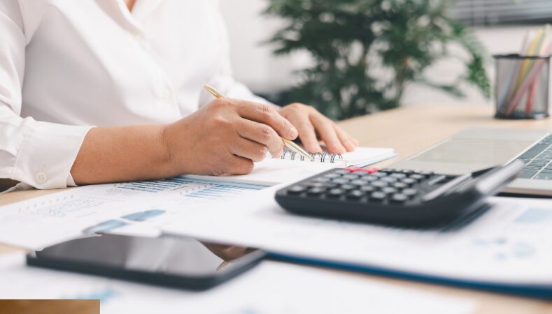 Small business owner reviewing a financial plan and cash flow forecast
